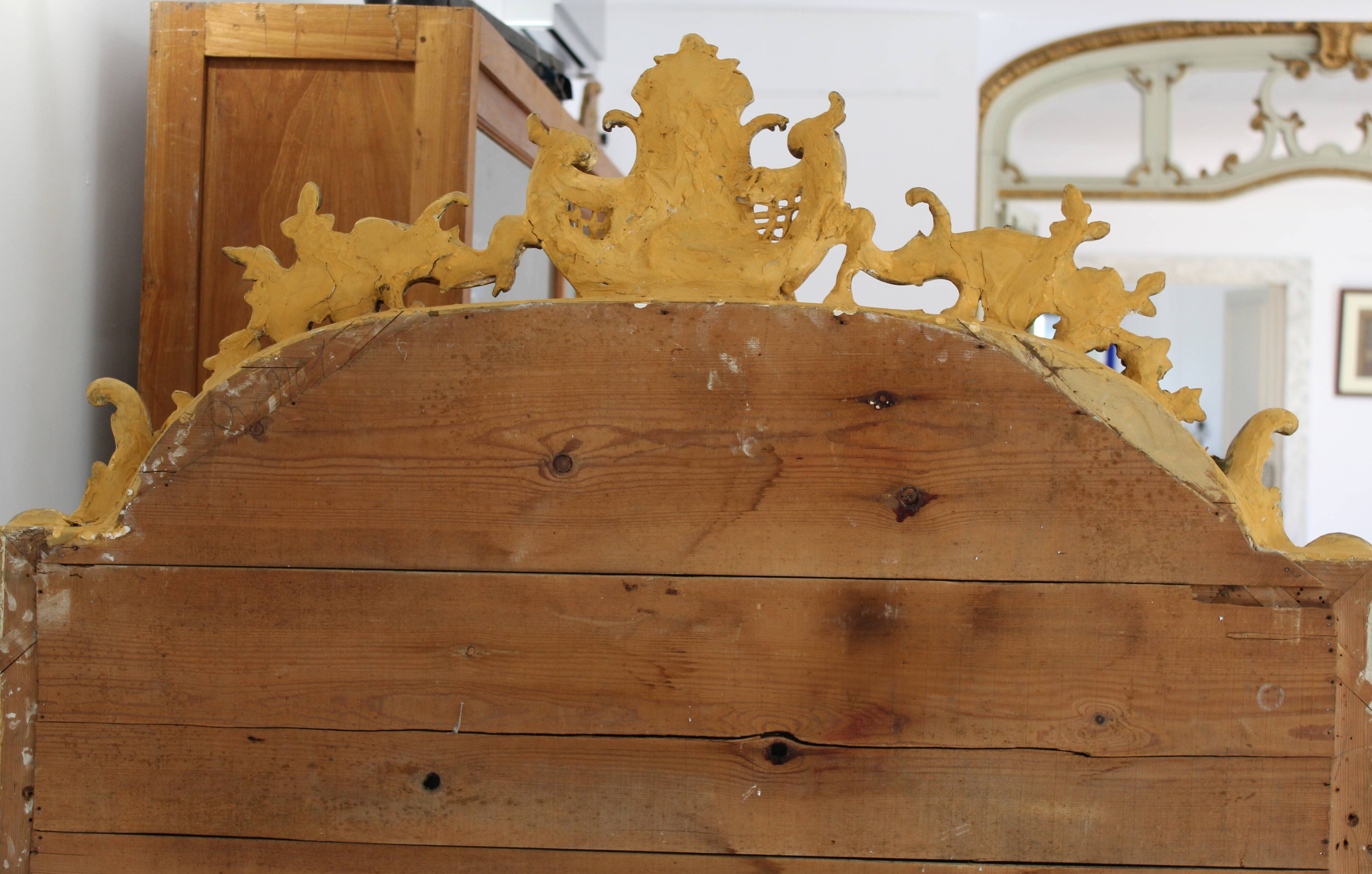 Large 19th-century wooden and gilt-studded mirror decorated with a cornucopia motif.