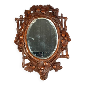 Ancien miroir biseauté en bois sculpté patine cirée