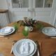 Walnut table with raised flaps, base on verdigris casters.