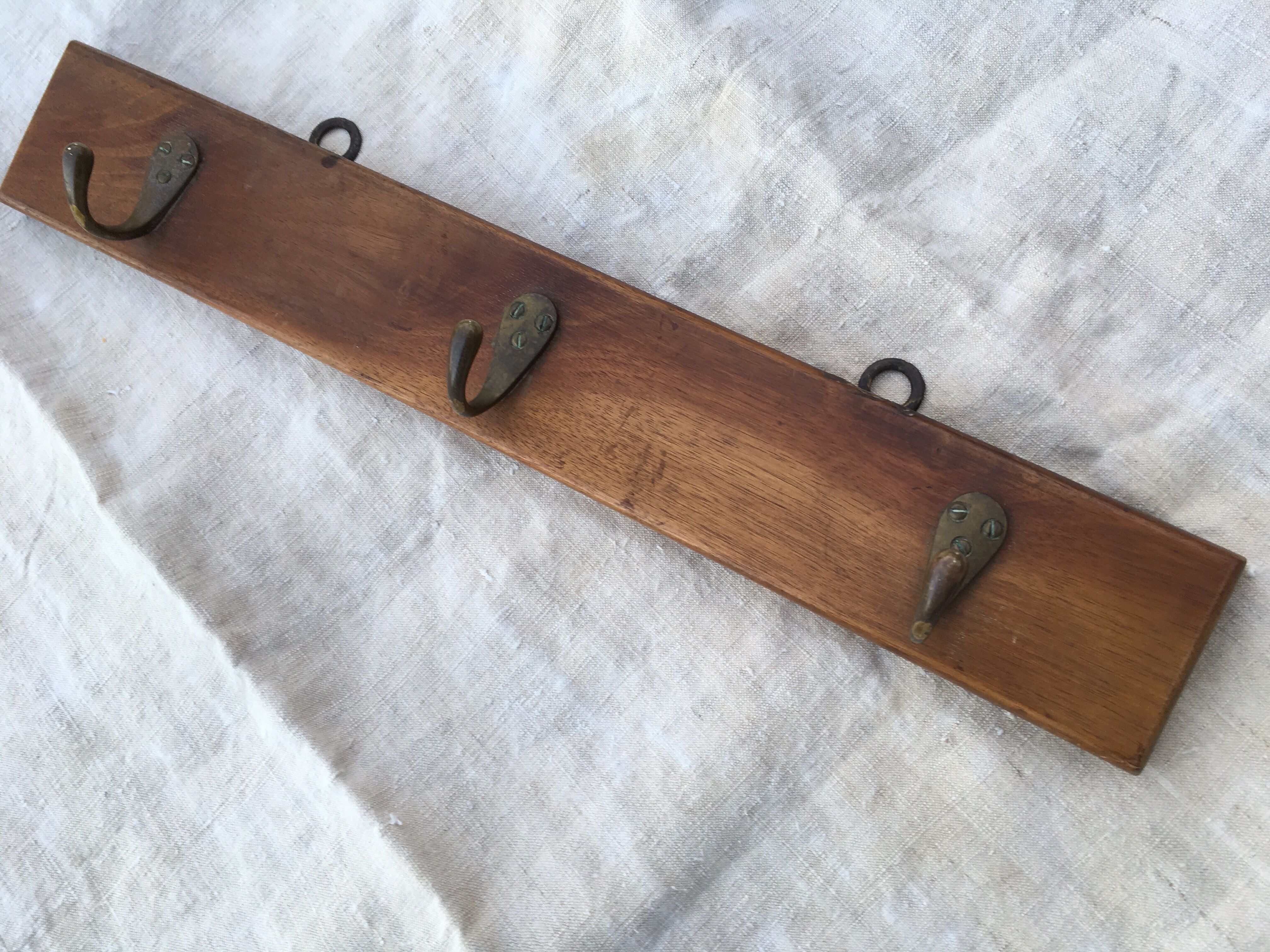 Wall hook from wood and brass