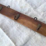 Wall hook from wood and brass