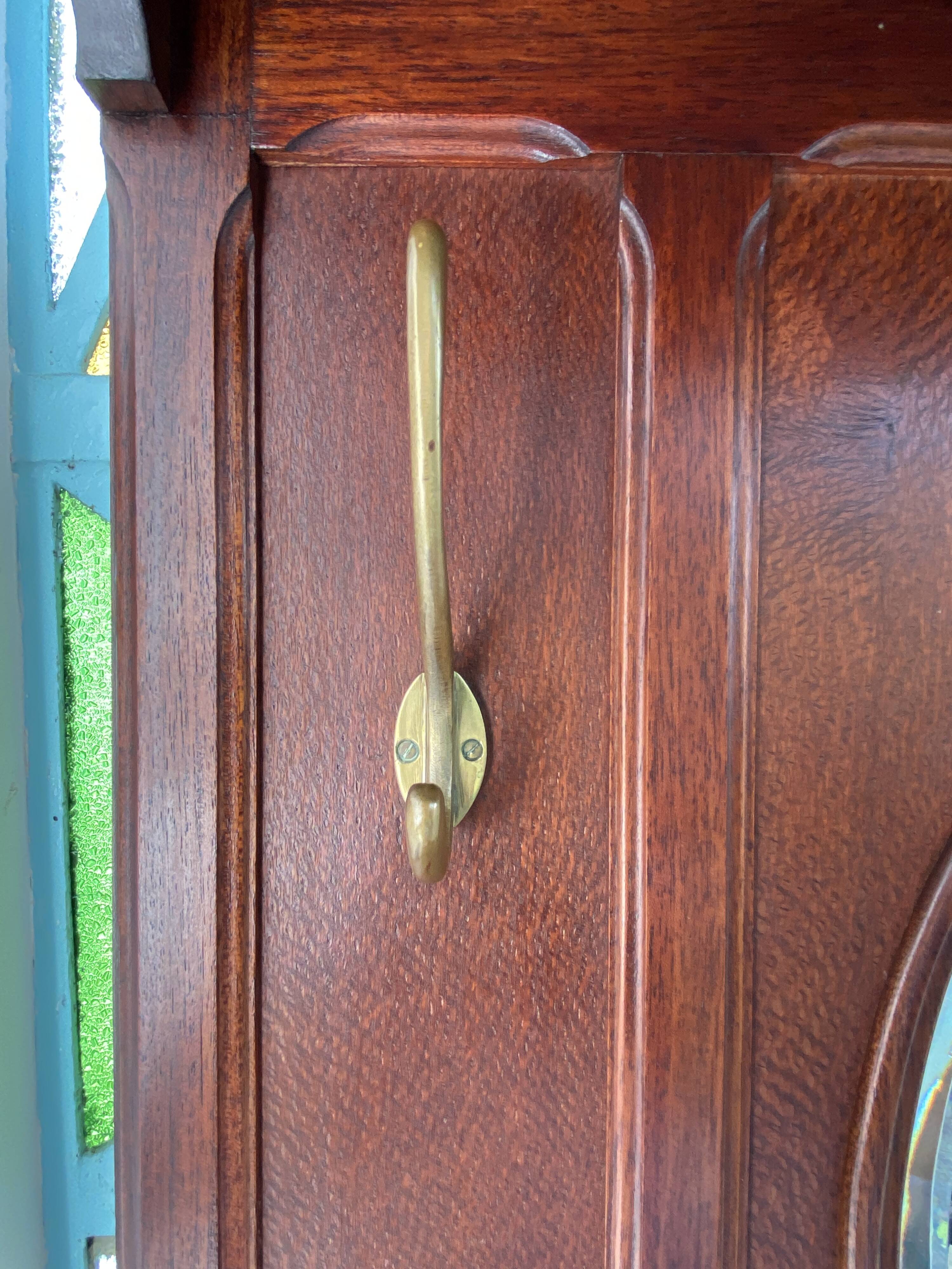 Antique wooden coat rack with mirror and shelf.
