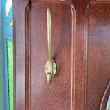 Antique wooden coat rack with mirror and shelf.