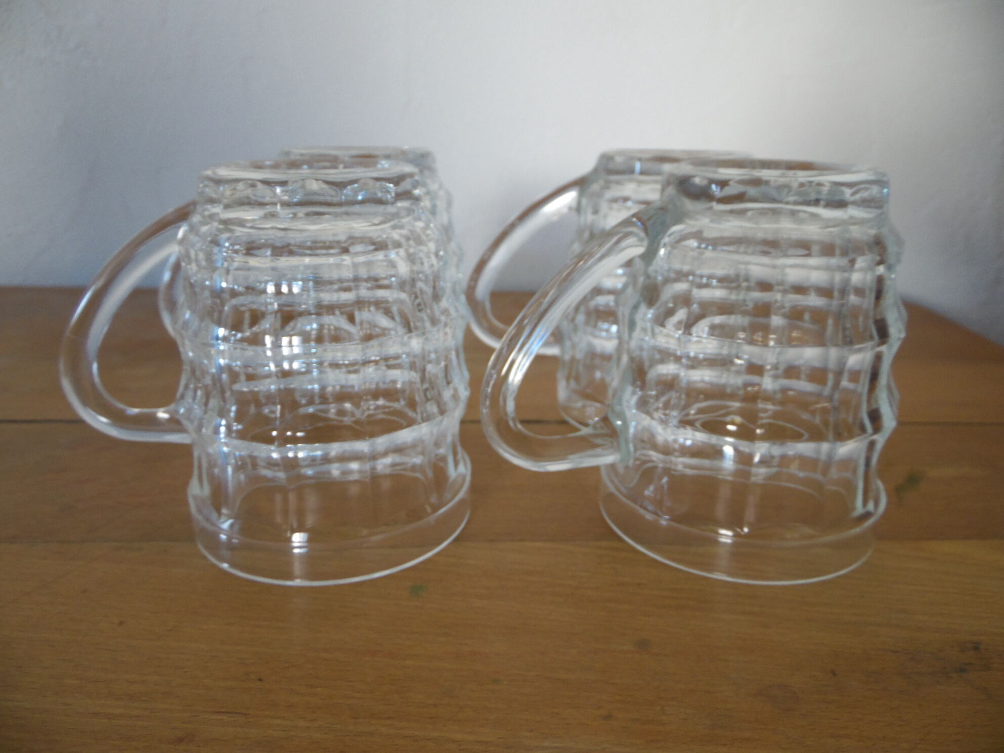 4 transparent glass mugs