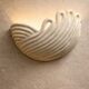 Draped ceramic wall light in a half-moon shape.