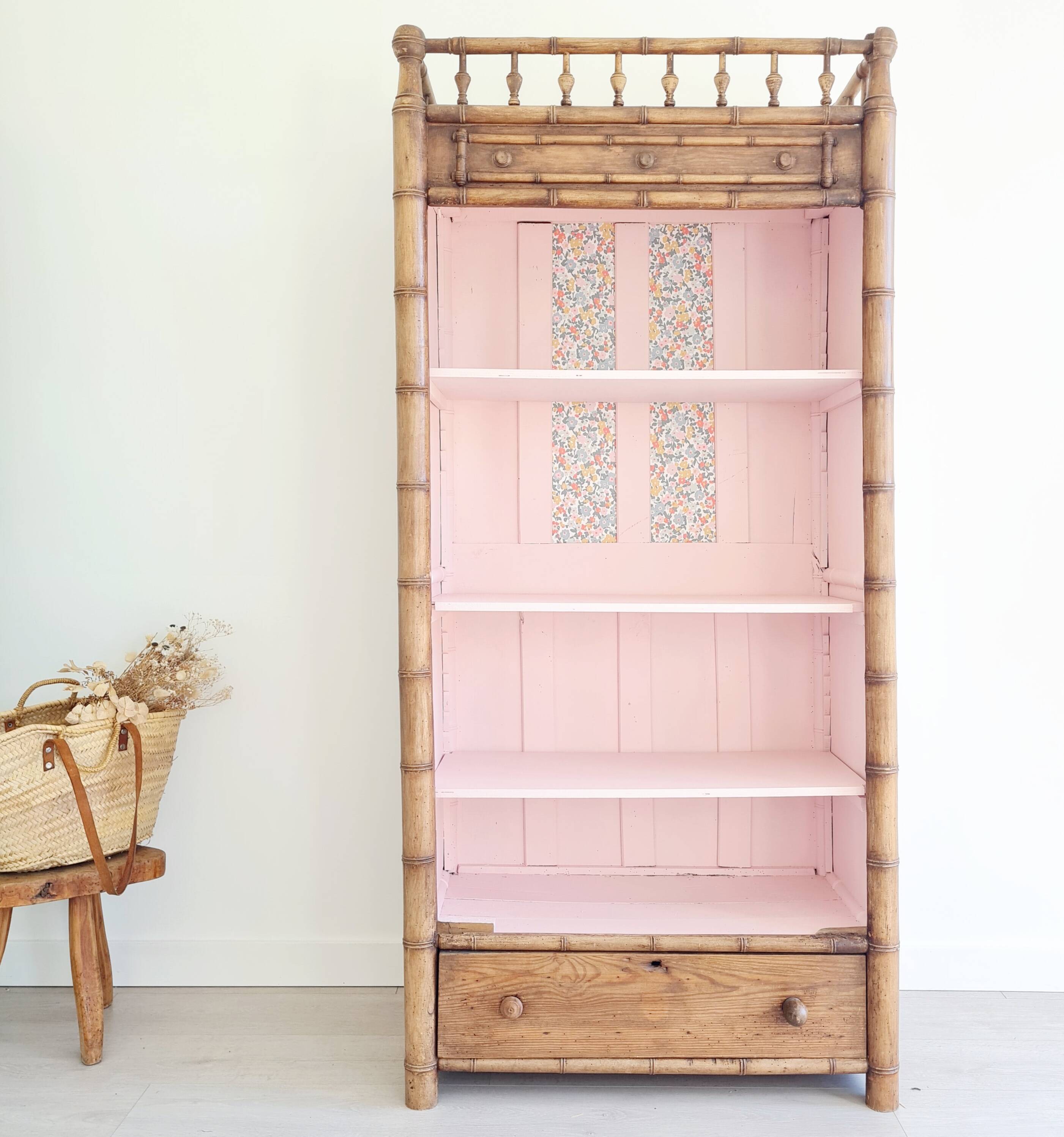 Library, old wooden cabinet imitating bamboo painted in pink