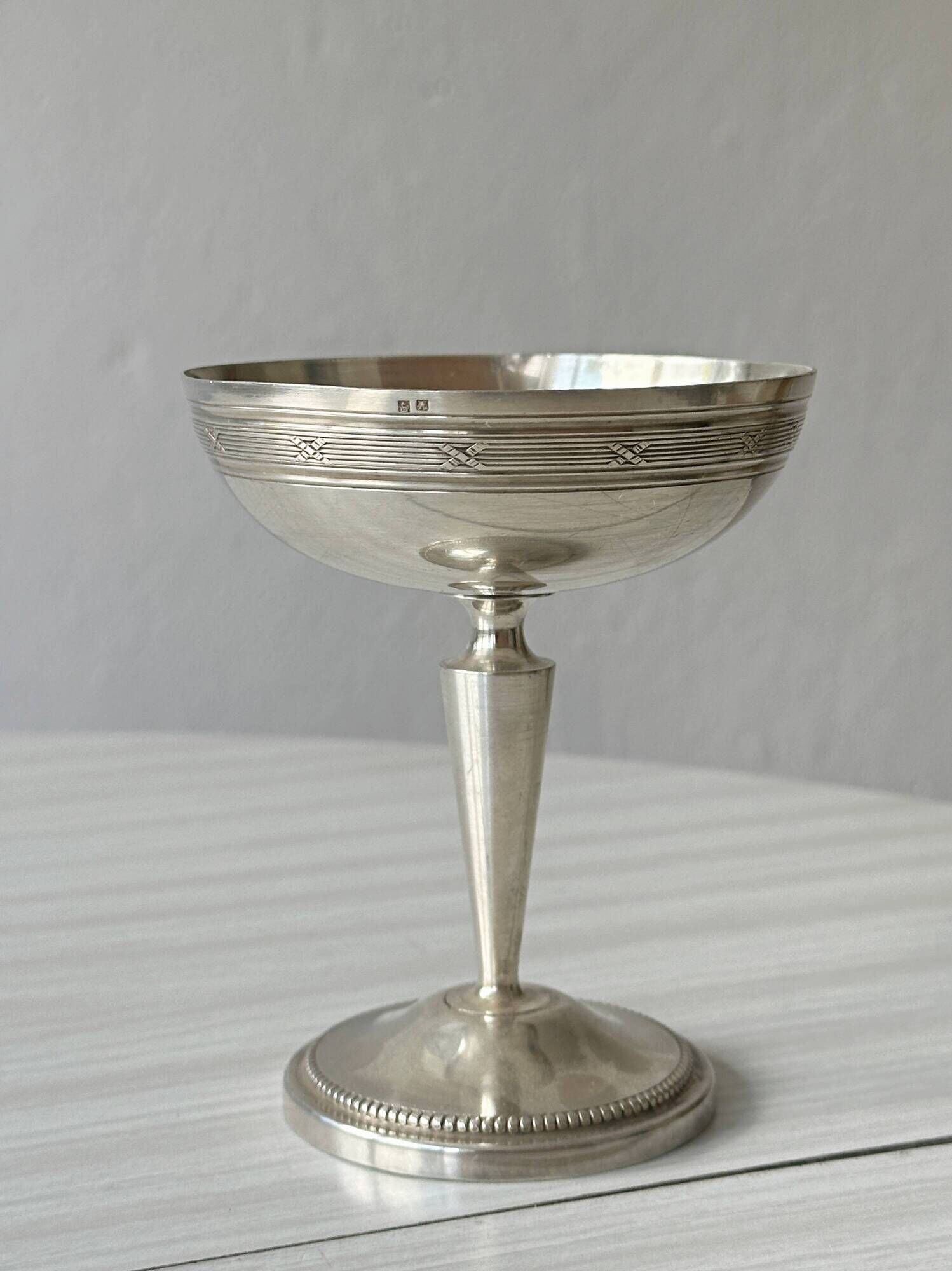 Silver-plated metal stand.