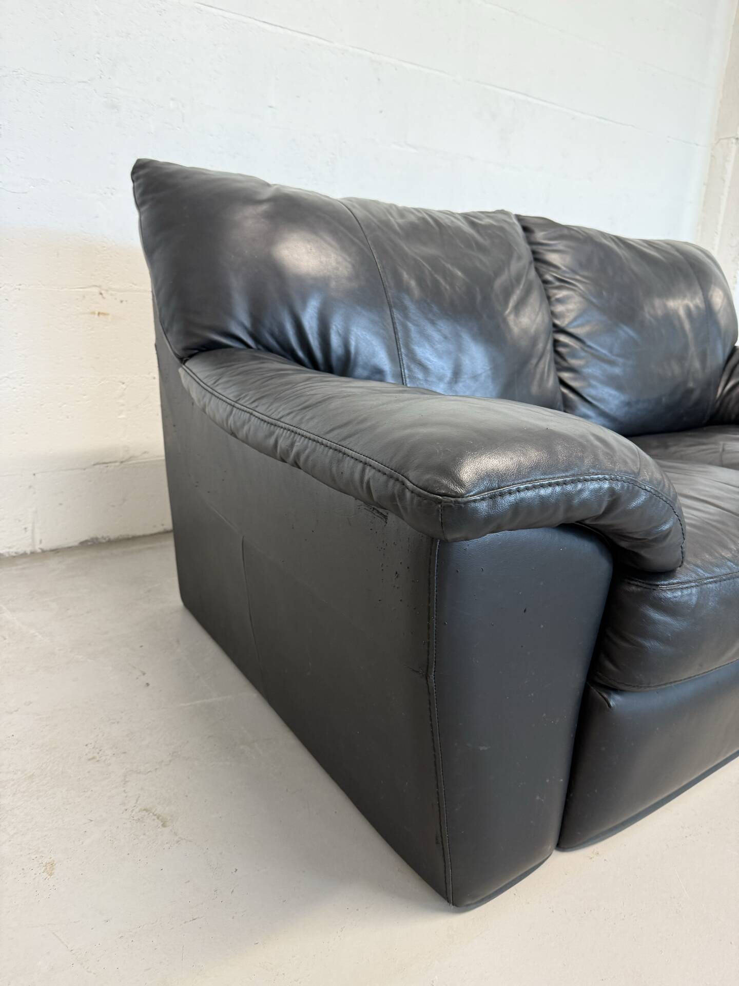 Two-seater black leather sofa — postmodern design