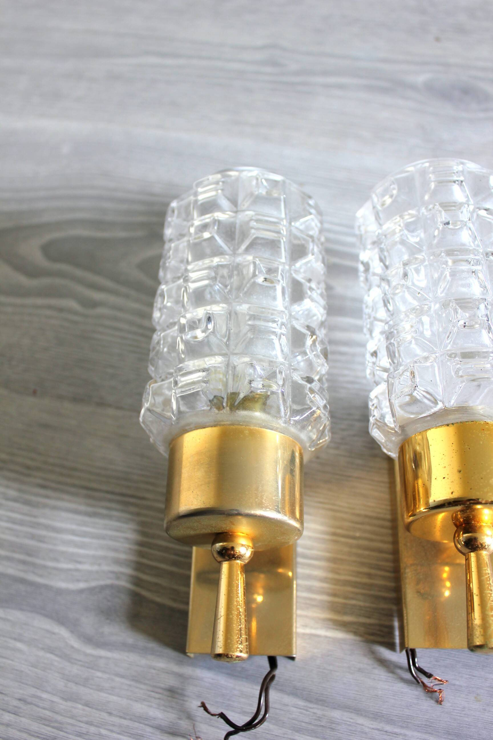 Pair of vintage wall sconces in gilded brass with moulded glass.