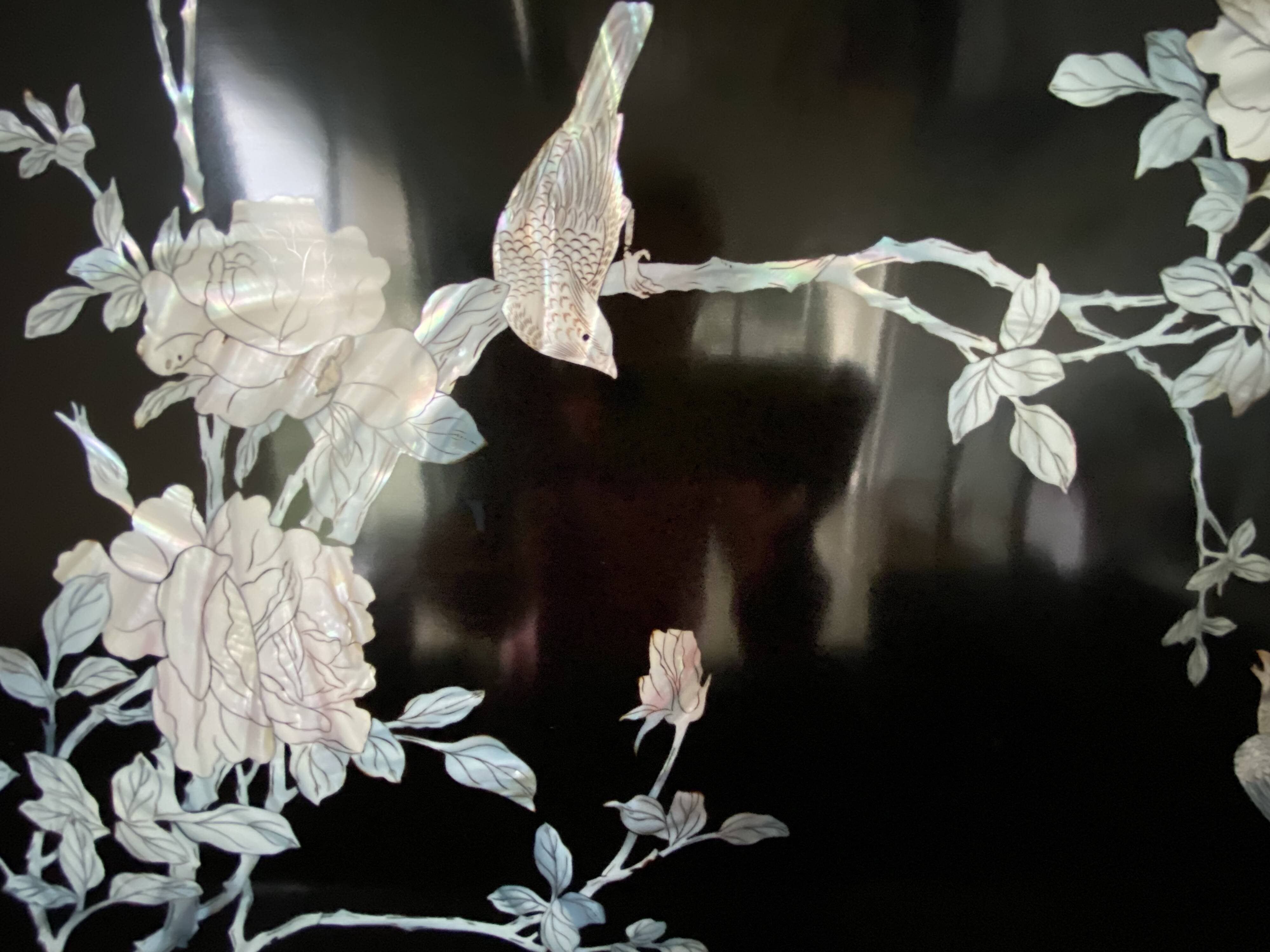 Black lacquered artisanal bar with mother-of-pearl inlays.