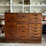 Craftsman's cabinet with 16 drawers in dark wood.