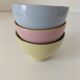 Set of three pastel two-tone mini bowls in glazed ceramic.
