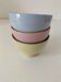 Set of three pastel two-tone mini bowls in glazed ceramic.