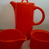 Coffee pot has orange 1970 sugar milk