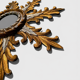 "Witch mirror 'Sun' in gilded wood with acanthus leaf decoration"