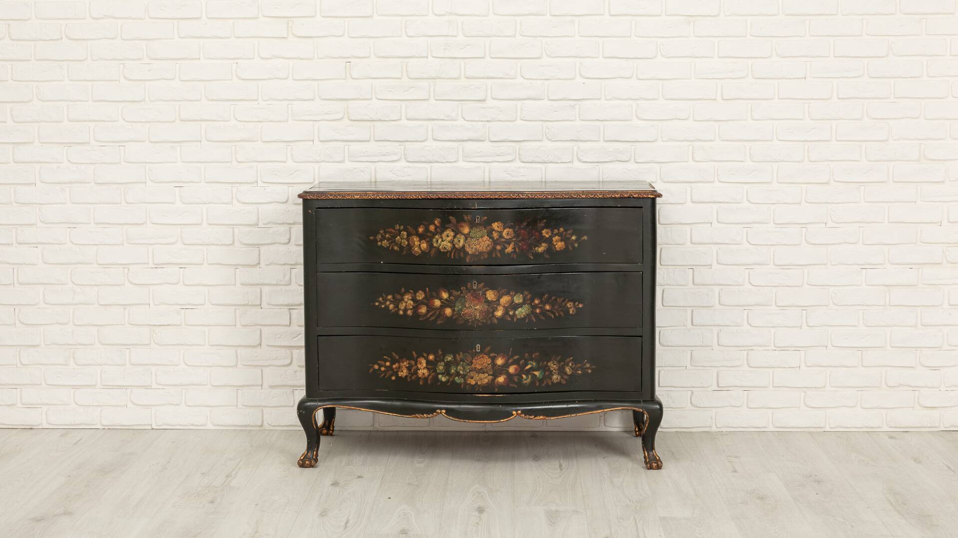 Green chest of drawers with floral decorations