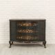 Green chest of drawers with floral decorations
