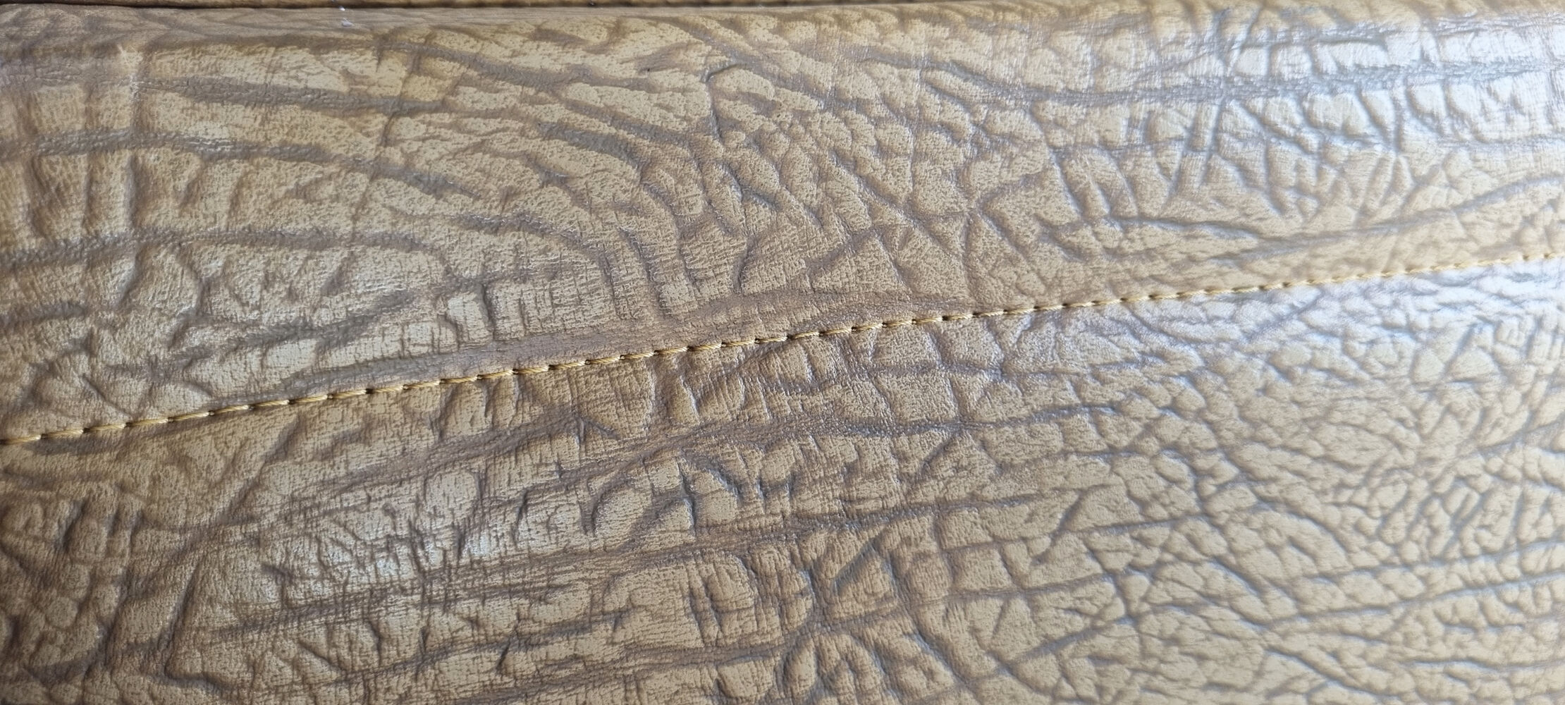 Pair of mustard skaï armchairs, brass feet