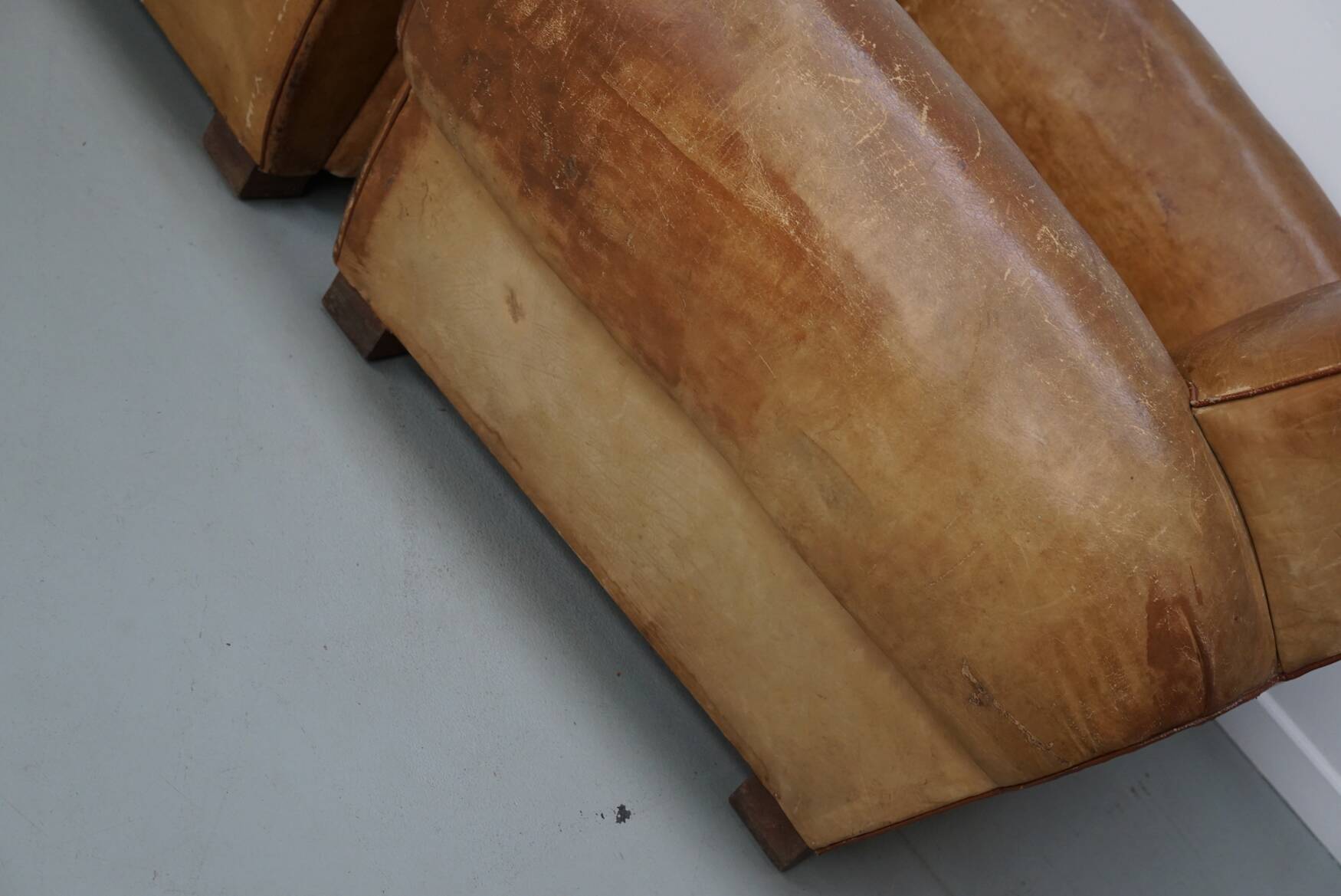 Pair of French club chairs with moustache back in cognac leather, 1940s
