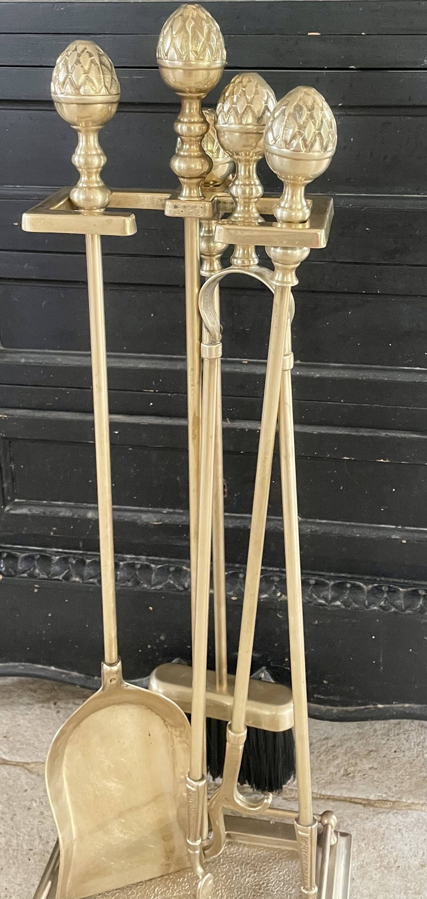 Brass fireplace tools in the style of Maison Baguès.