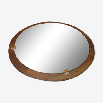Round mirror in a vintage teak wood frame