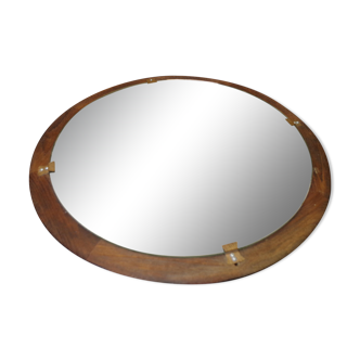 Round mirror in a vintage teak wood frame