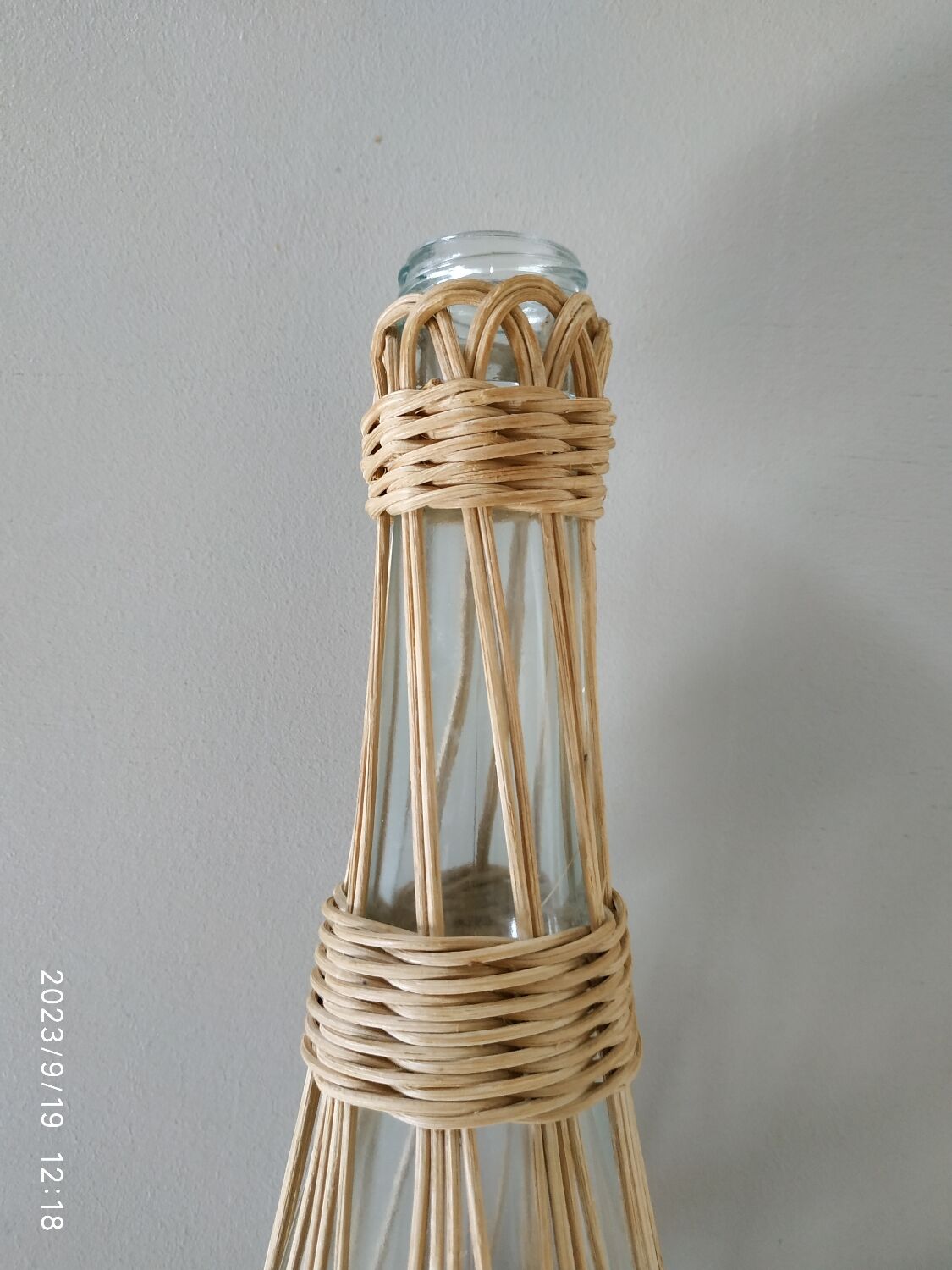 Glass and rattan bottle