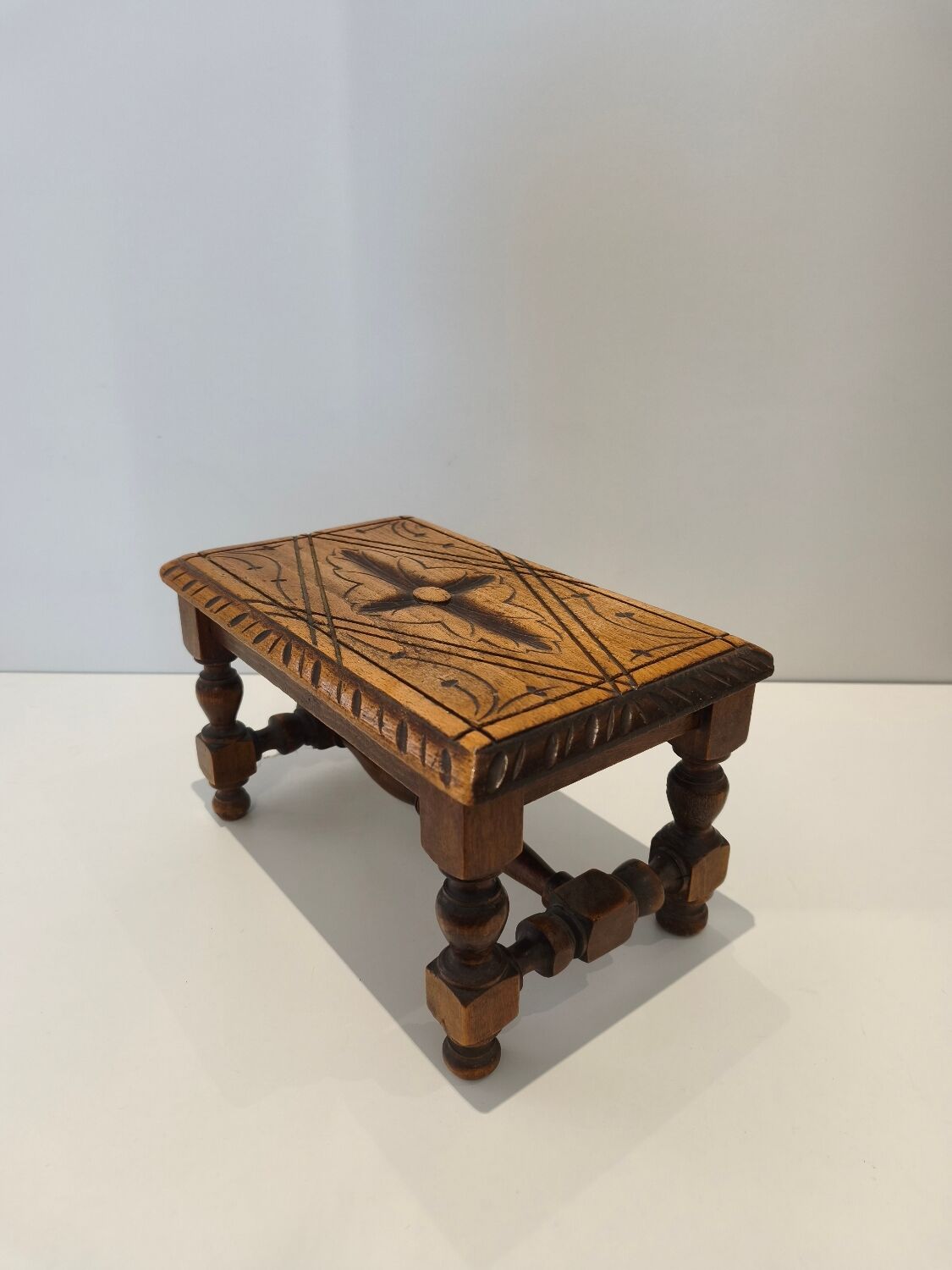 Small vintage carved solid wood footrest bench