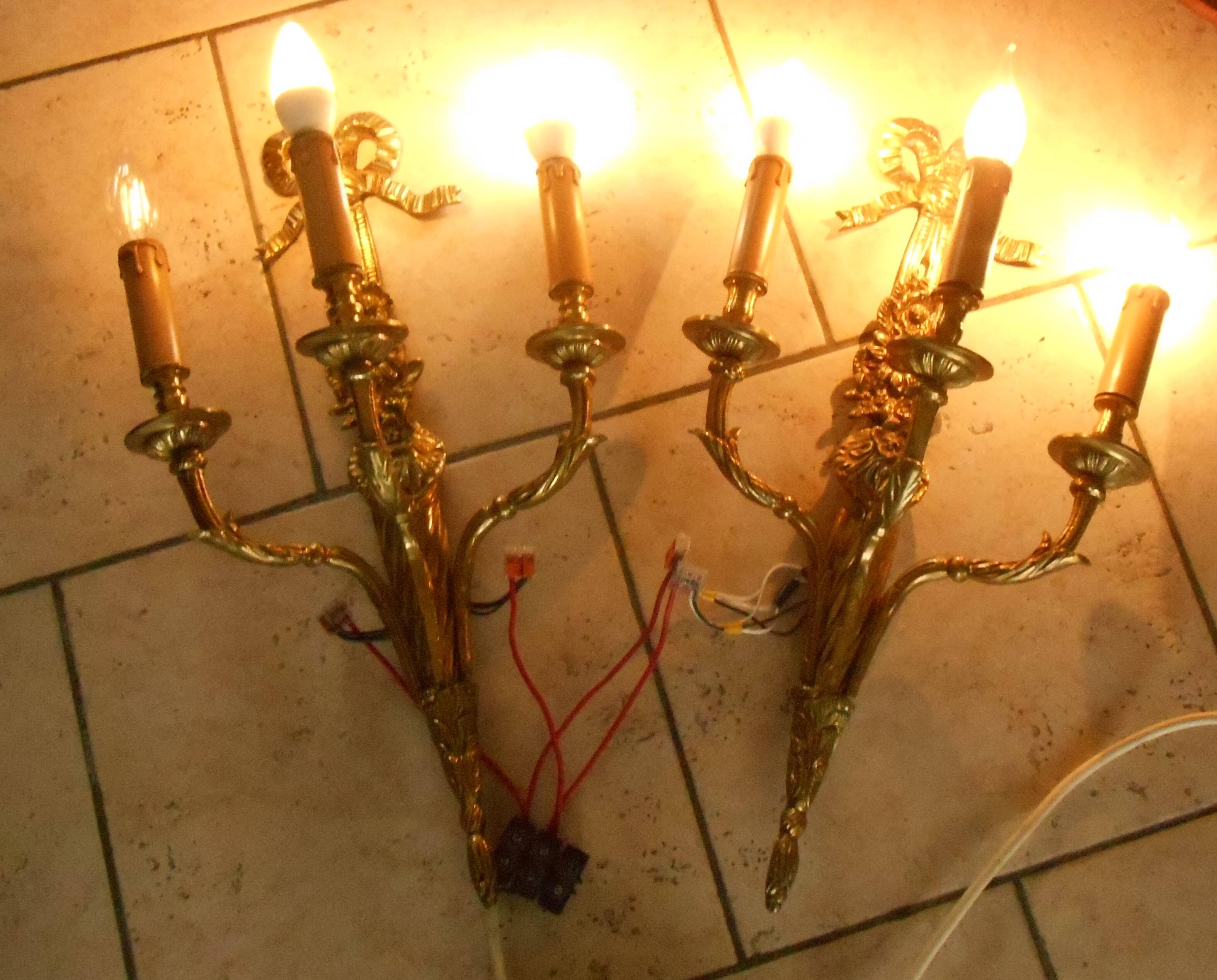 Pair of gilded bronze wall sconces with three lights