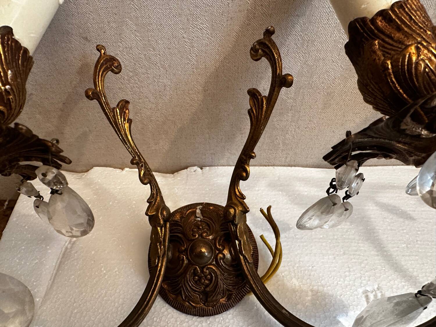 Pair of Louis XV style wall sconces in gilded bronze with glass pendants.
