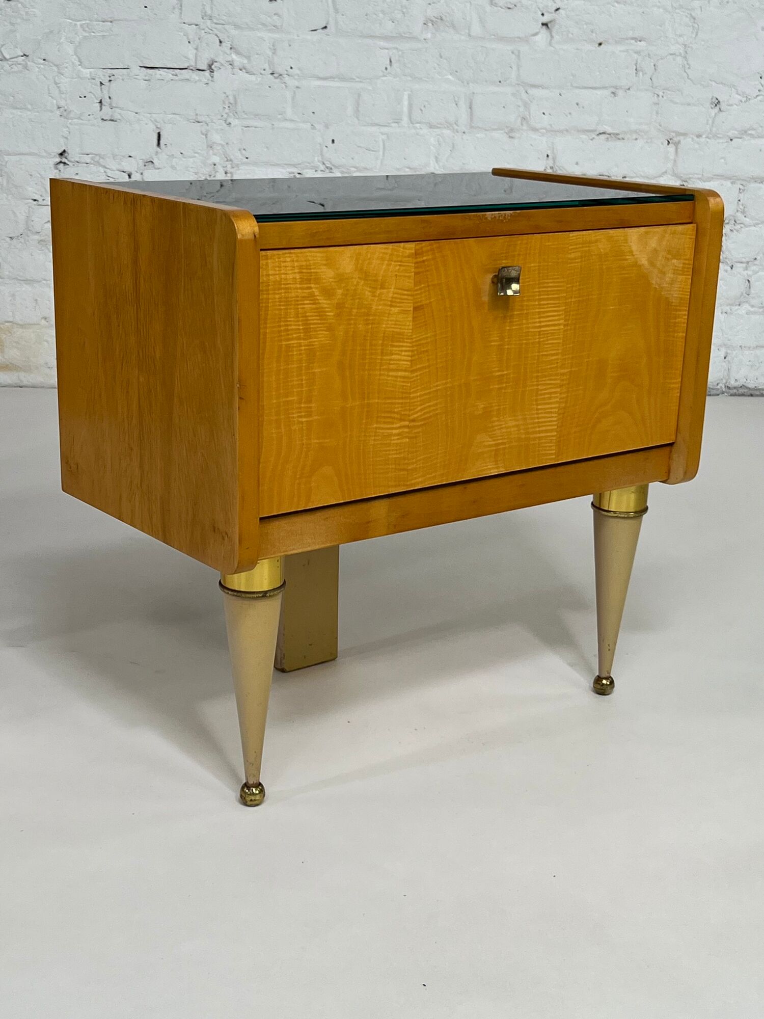 Pair of bedside tables in wood, brass and black glass top