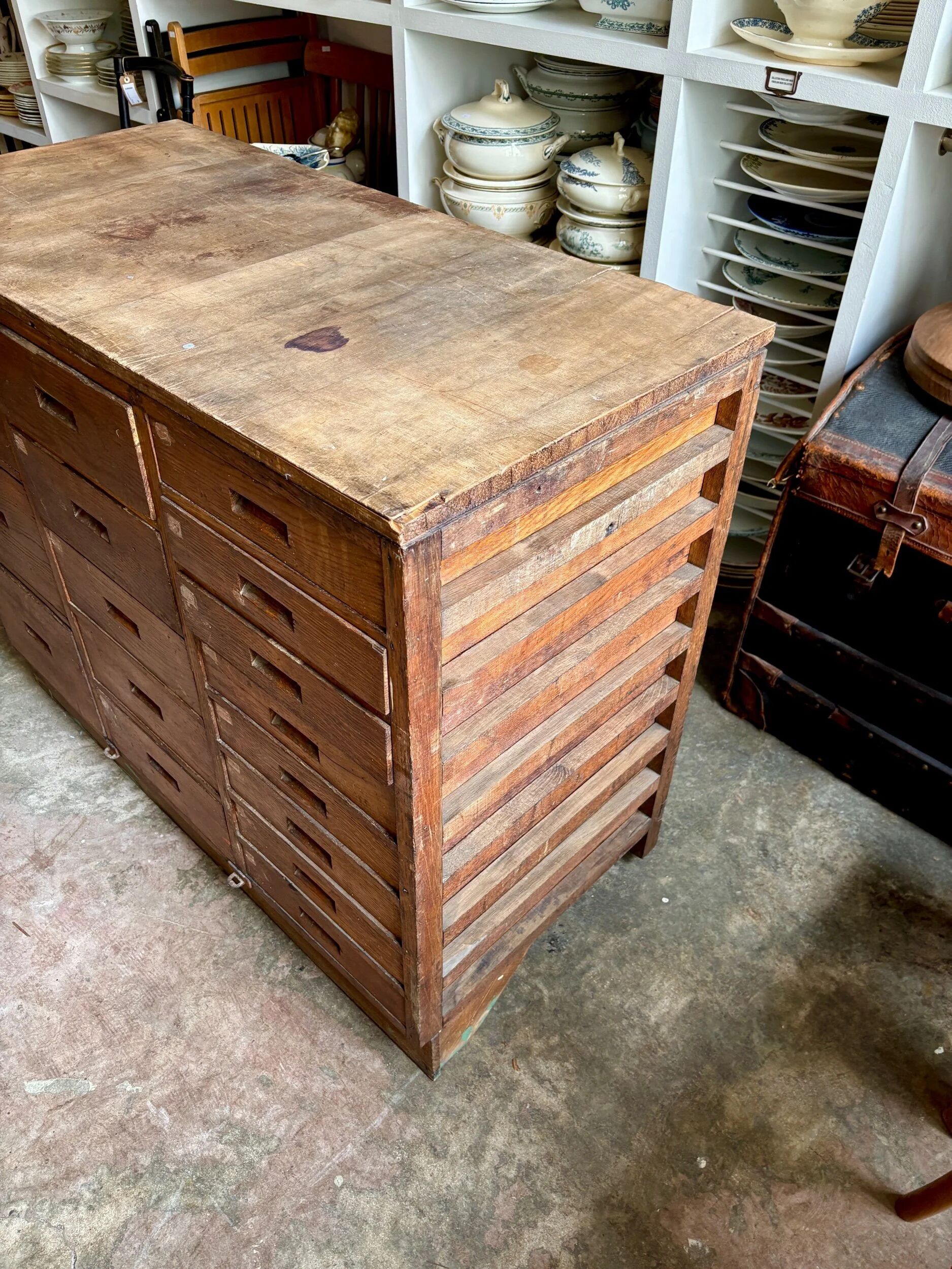 Craftsman's cabinet with 16 drawers in dark wood.