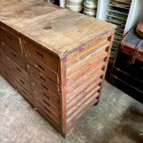 Craftsman's cabinet with 16 drawers in dark wood.