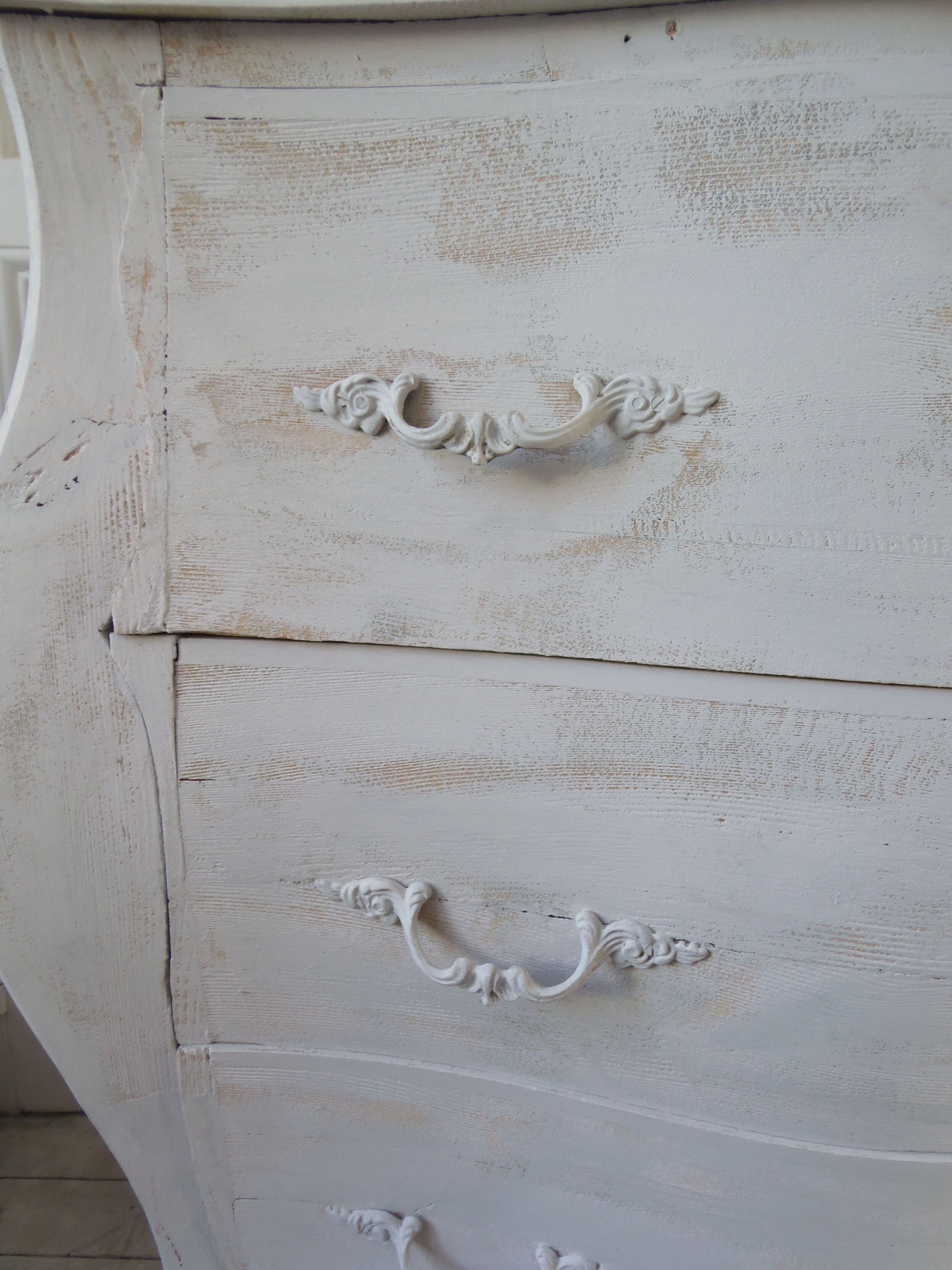 Curved patinated chest of drawers pearl grey waxed finish