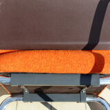 The 1970s orange armchair fabric and chrome metal