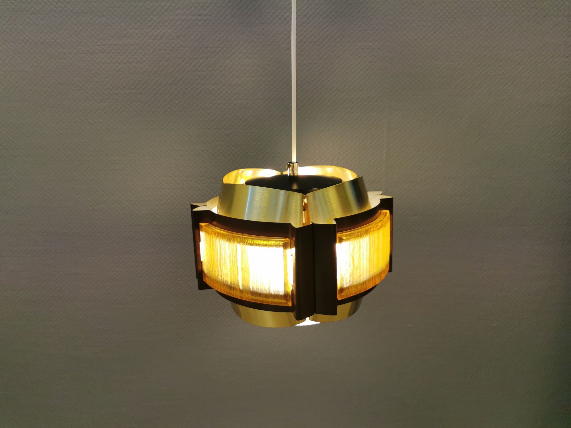 Danish hanging lamp, made in brass colored and brown metal, with yellowish hard pressed plastic deta