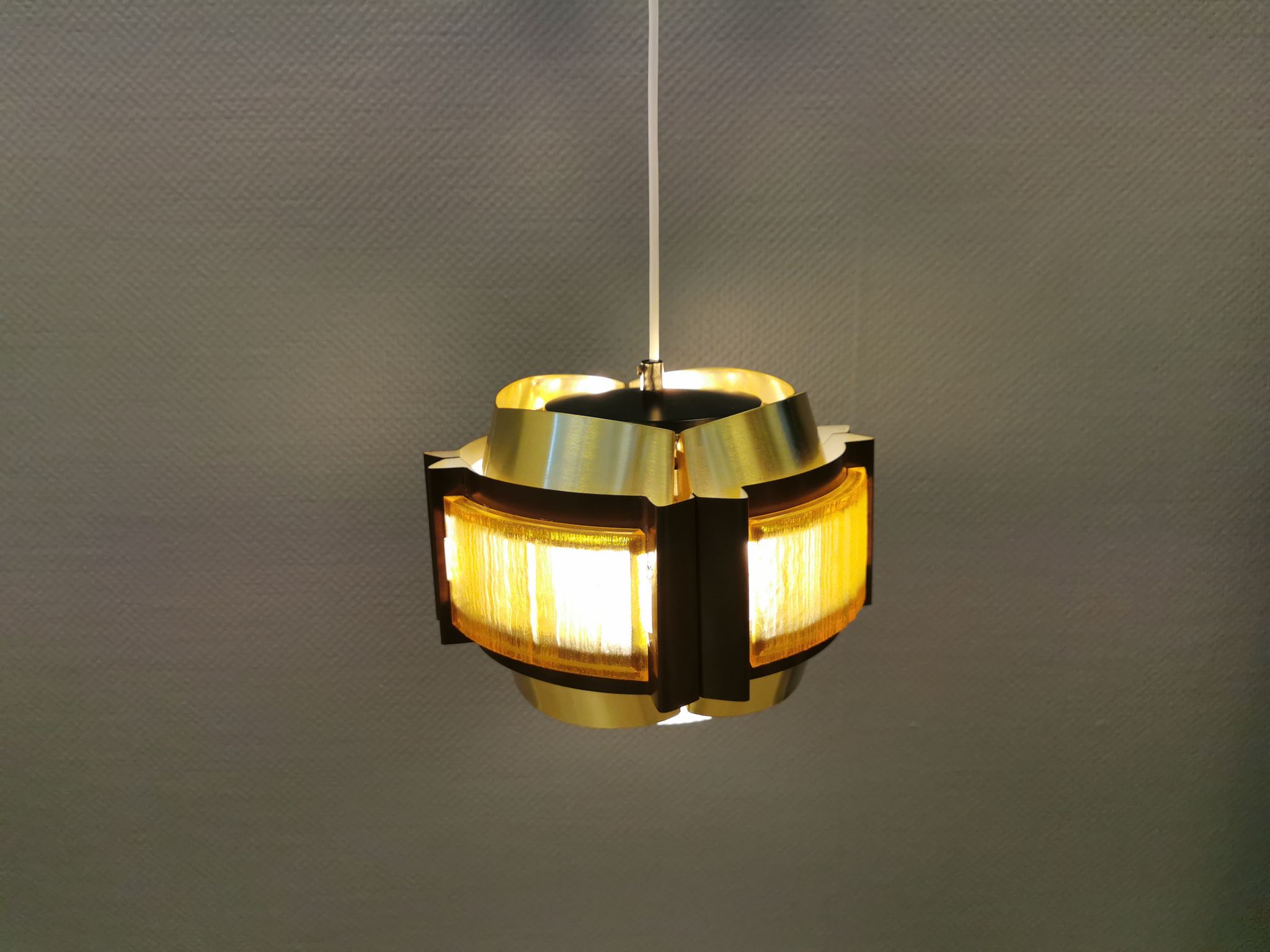Danish hanging lamp, made in brass colored and brown metal, with yellowish hard pressed plastic deta