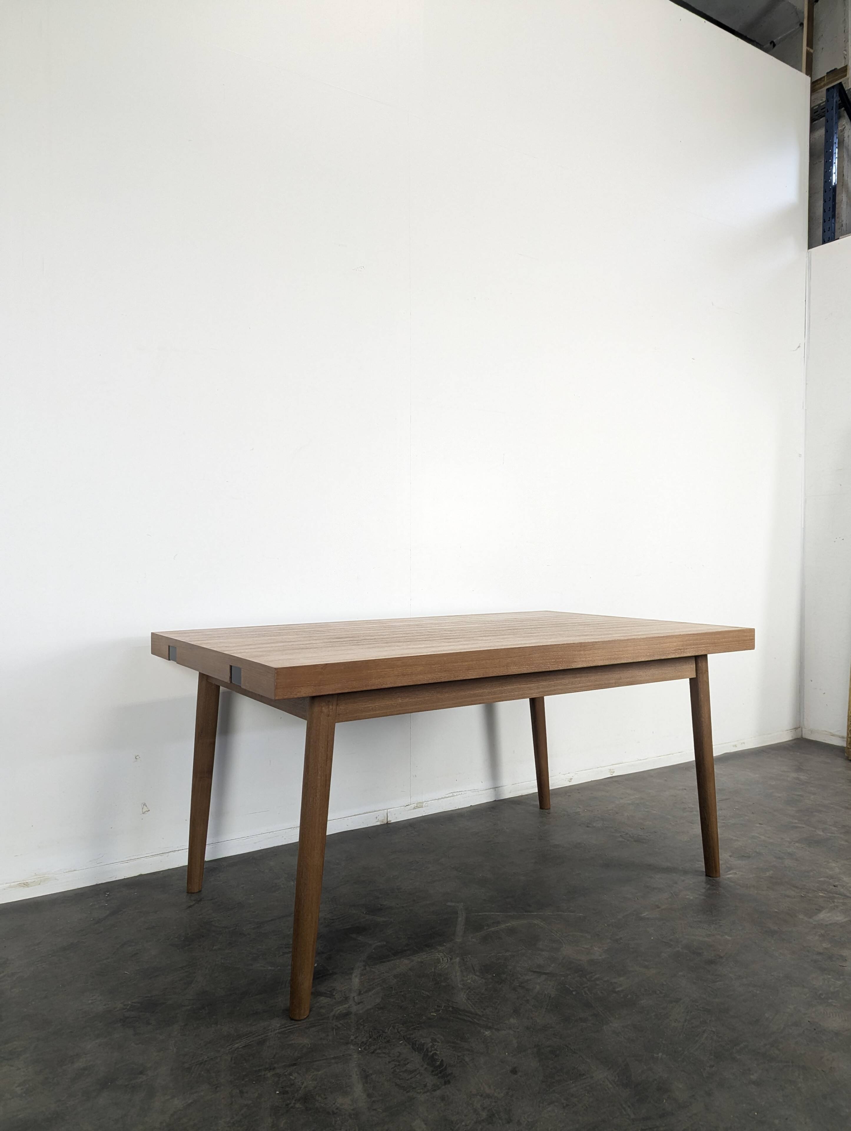 Modernist teak table with 2 extensions.