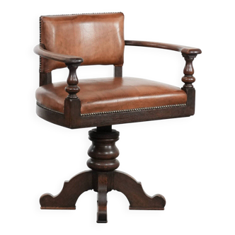Elegant antique sheepskin leather desk chair with a heavy wooden frame