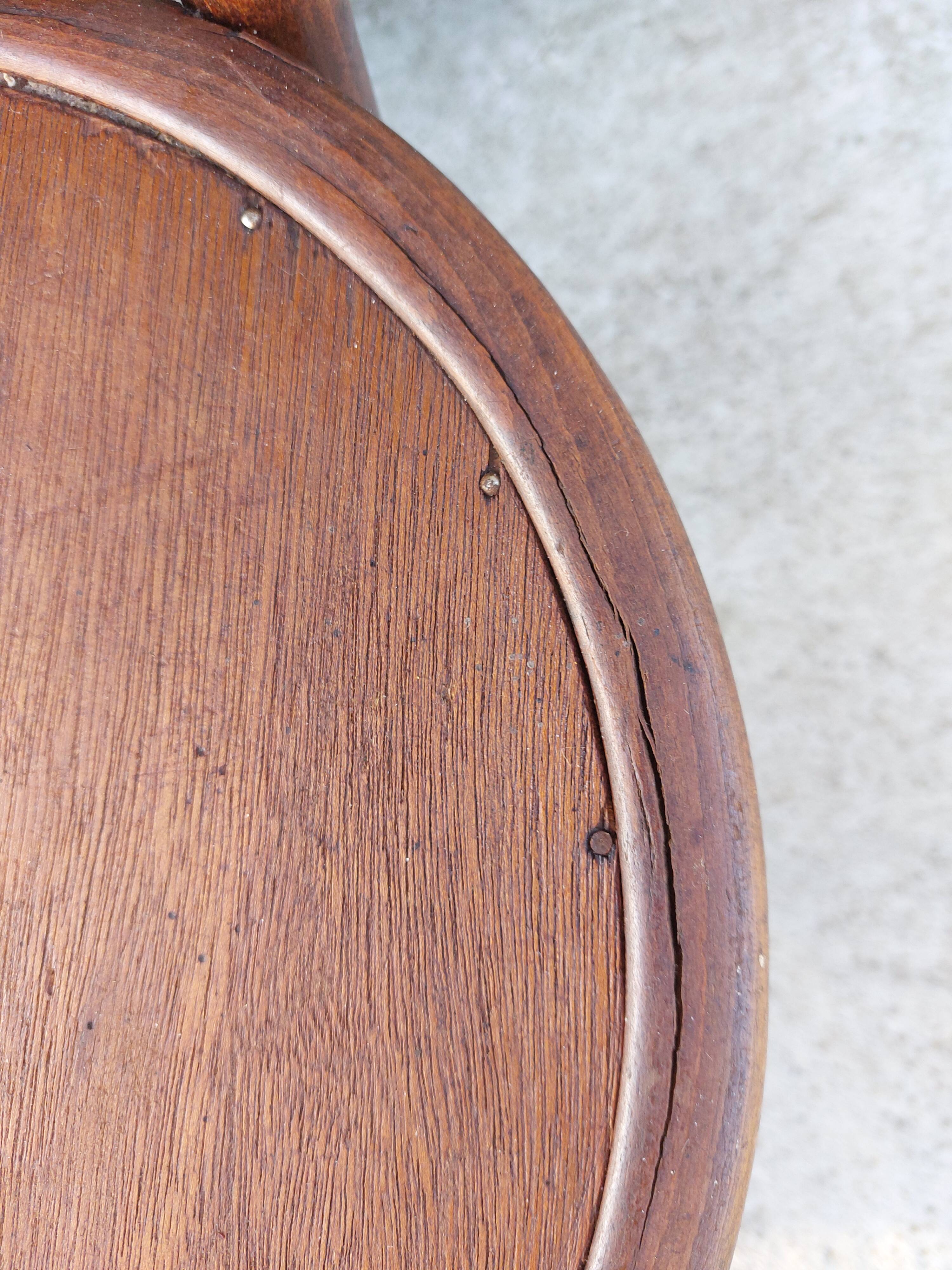 pair of round wooden chairs with a pattern on the seat