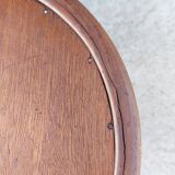 pair of round wooden chairs with a pattern on the seat