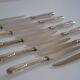 12 silver metal table knives 25.5 cm