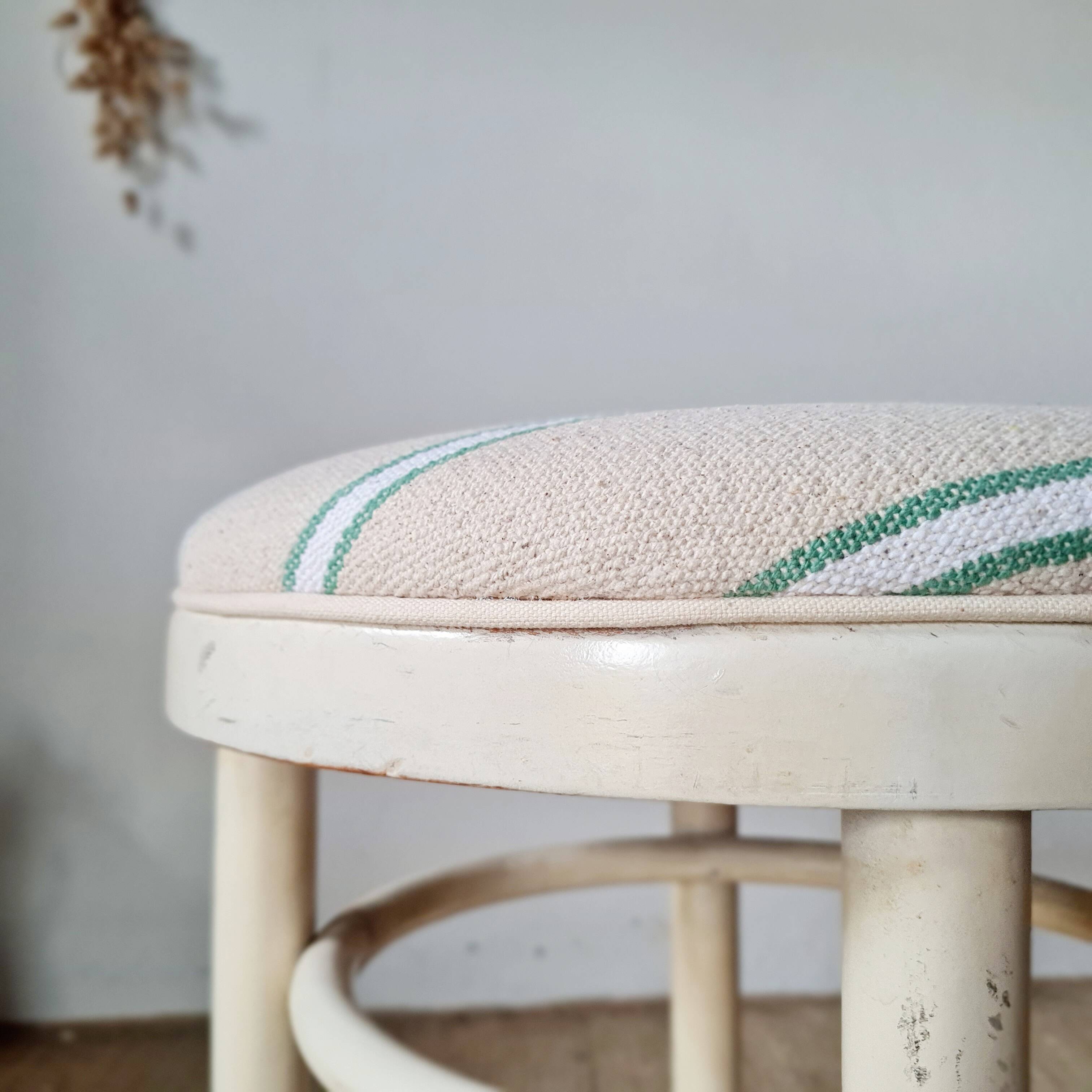 Vintage curved wooden stool in Baumann style, striped fabric seat.
