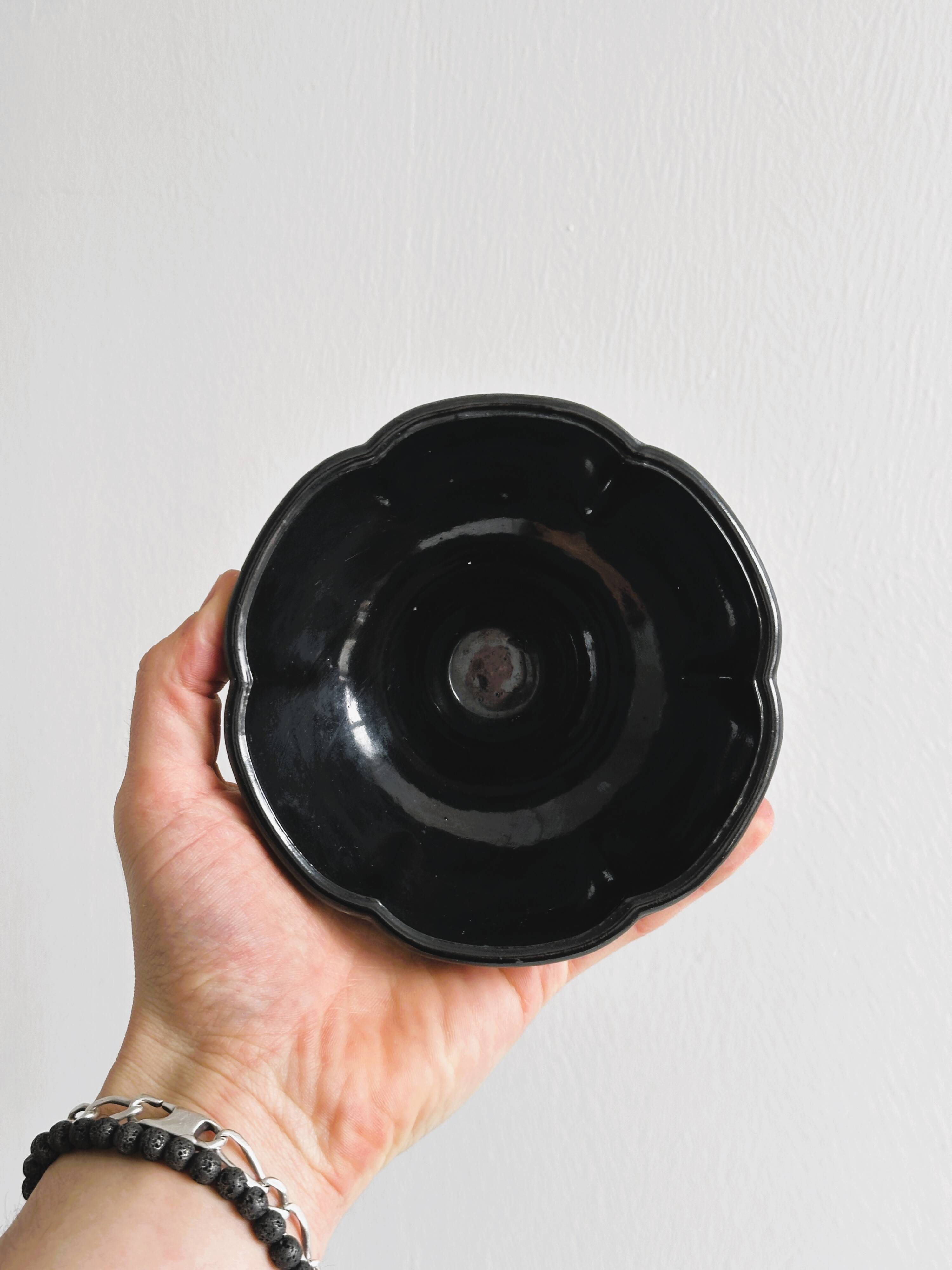 Small black glass cup