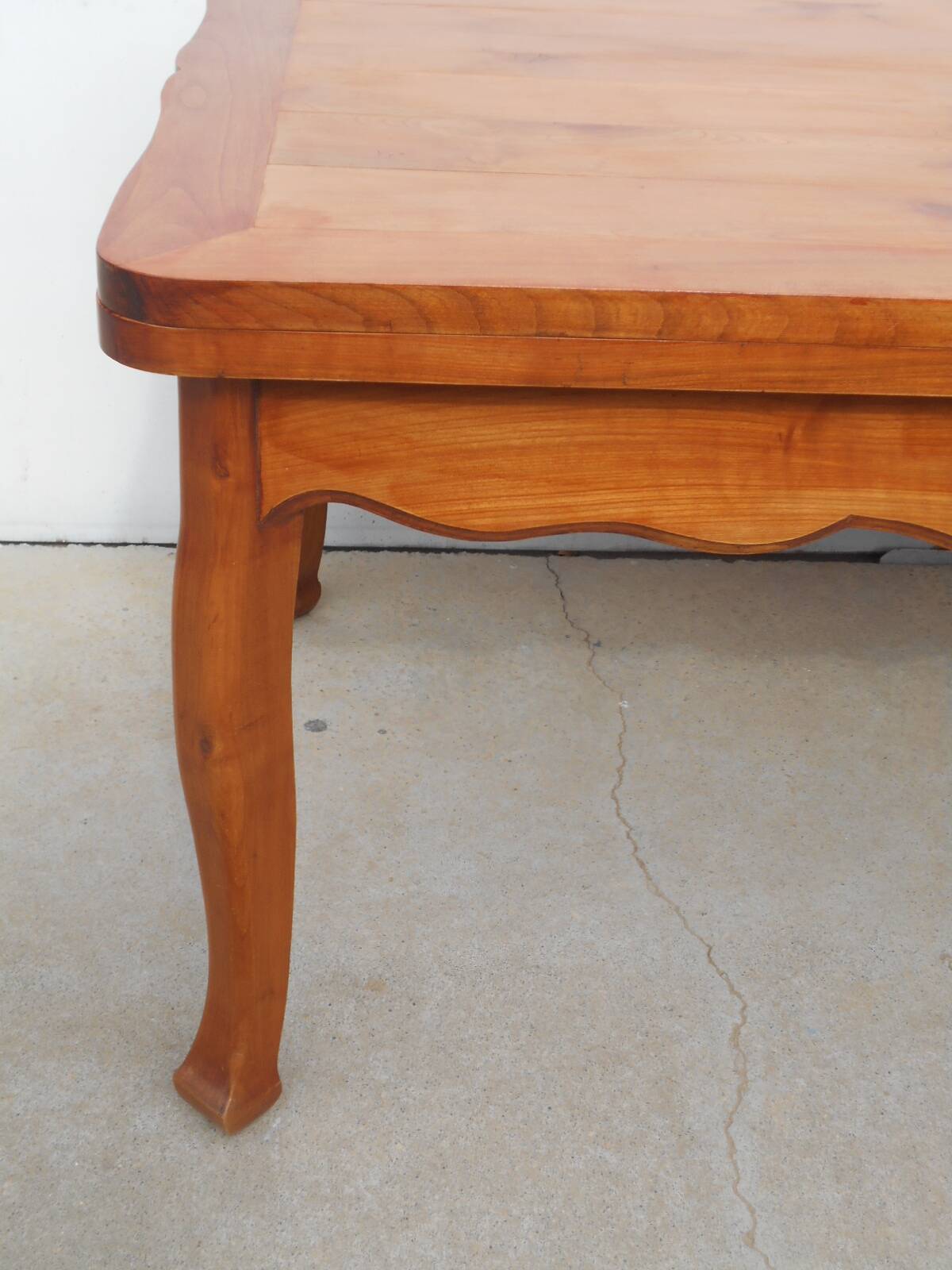 Large solid wood table with integrated extensions.