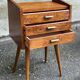 Scandinavian bedside table in oak from the 1960s with tapered legs and 3 drawers.