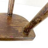 Ancient tripod milking stool - field theme, nature