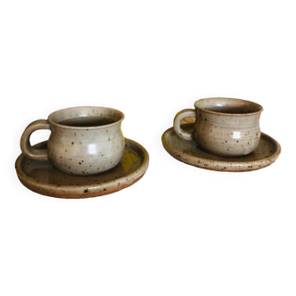 Duo of large cups in old speckled sandstone and their saucers
