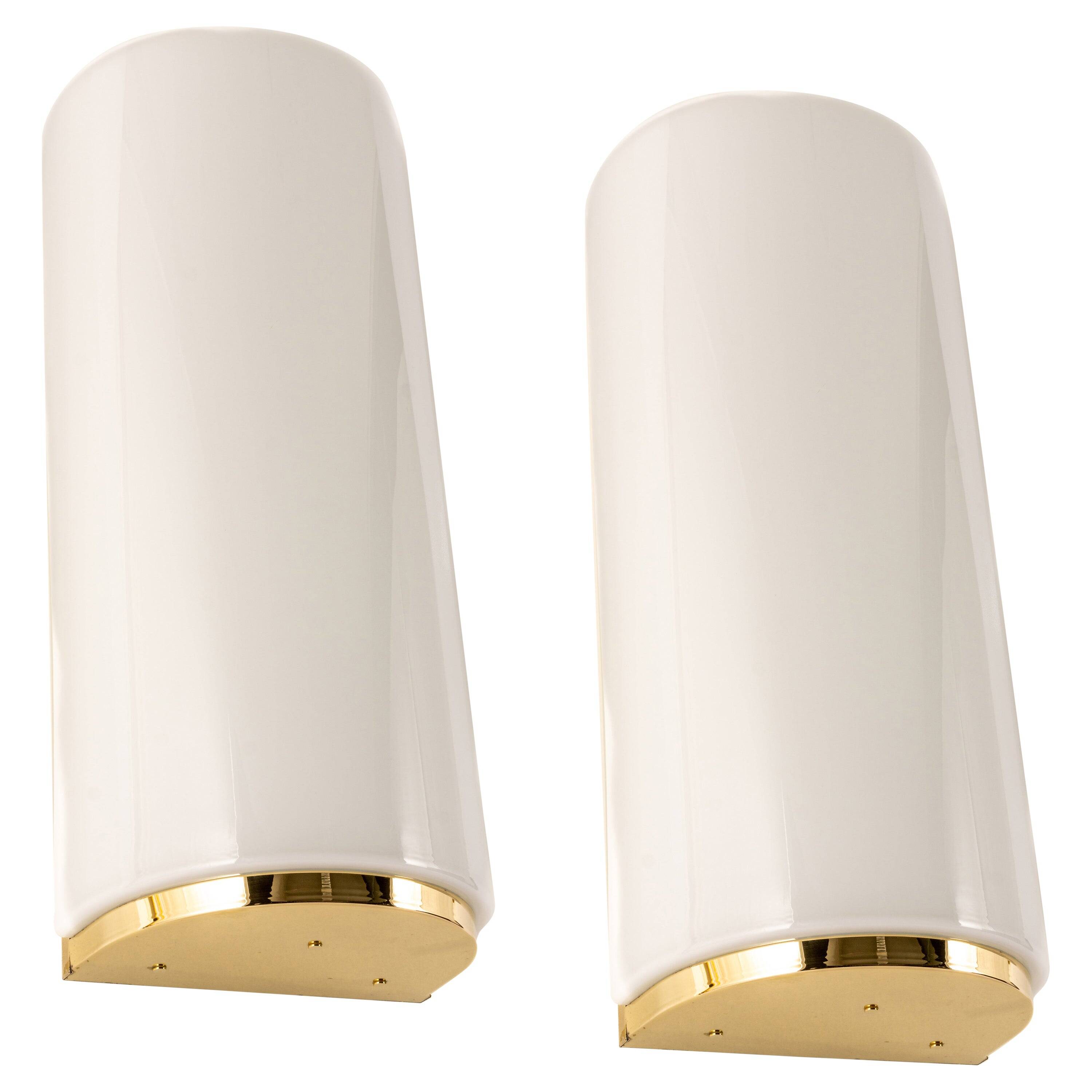 Pair of large opaline glass wall lights in brass designed by Limburg, Germany.