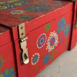 Red wooden trunk with floral patterns